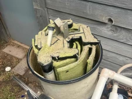 Filter grids caked with buildup pulled from a neglected Oklahoma City pool filter